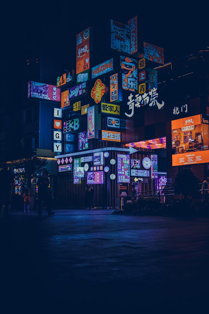Captivating night scene of colorful neon signs illuminating a bustling city street.