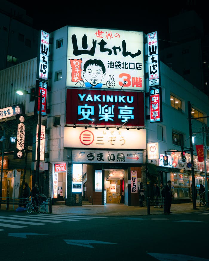Vibrant cityscape featuring illuminated signs and bustling nightlife in Ikebukuro, Tokyo.